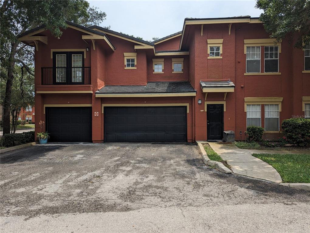 a front view of a house with a yard and a garage