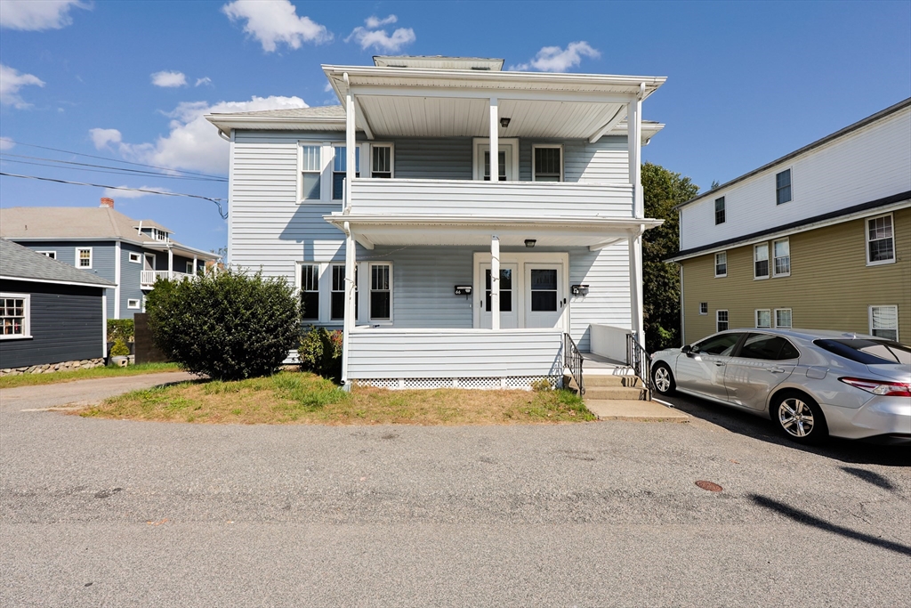 a view of a car park in front of house