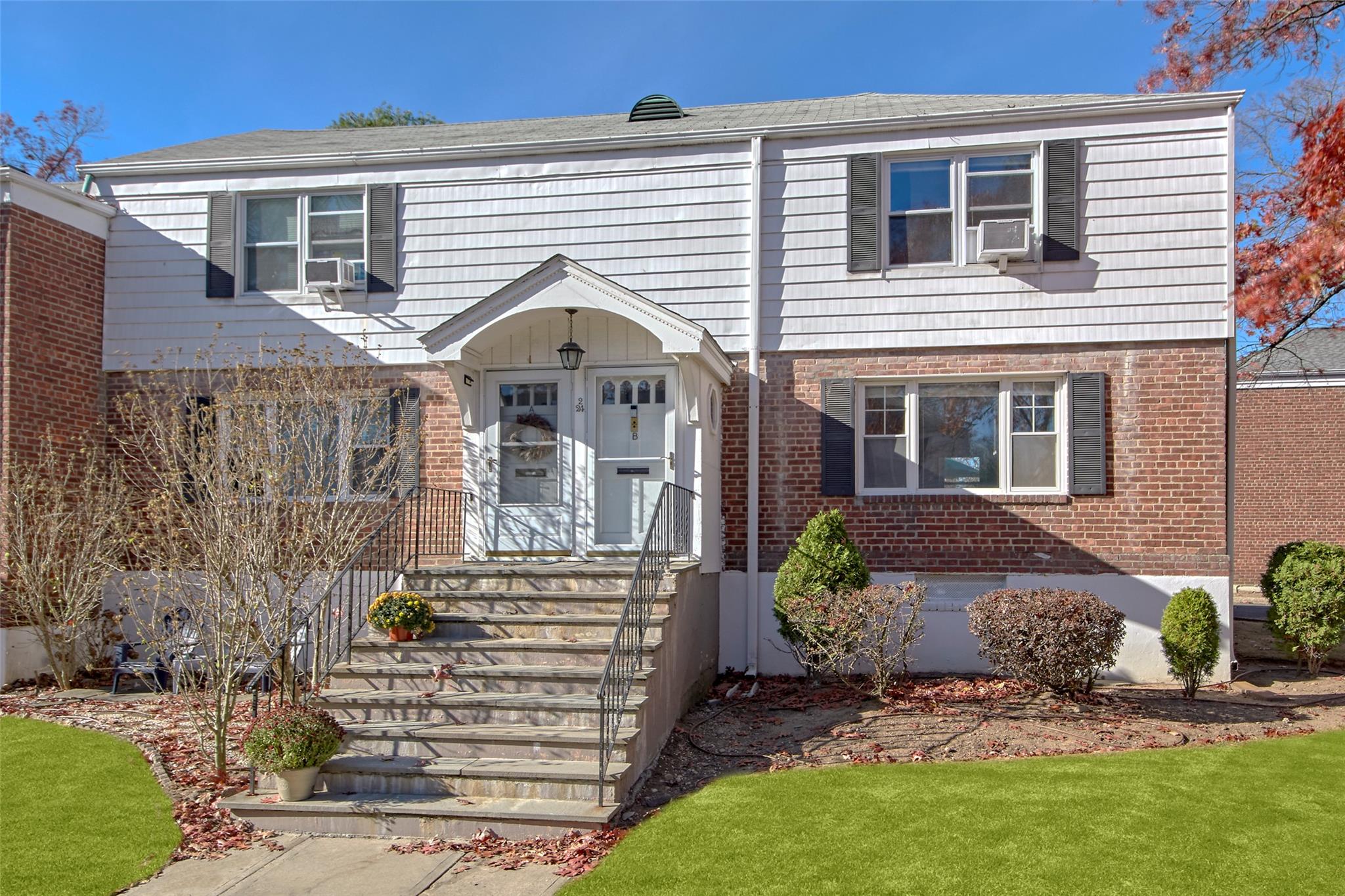 a front view of a house with a garden