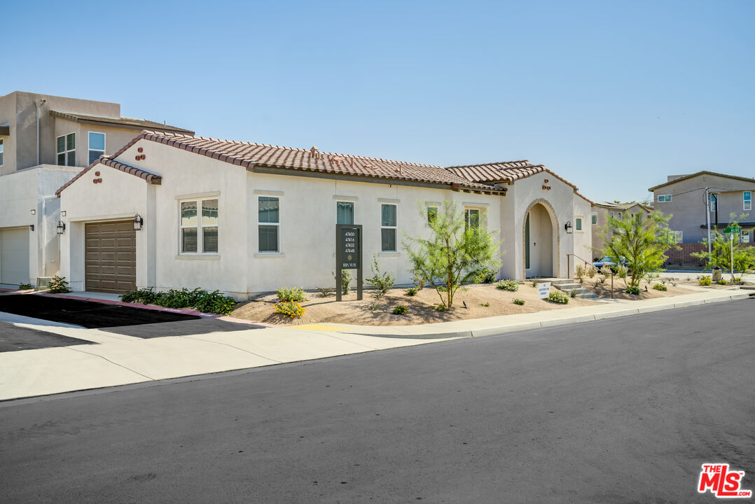 a view of a house with outdoor space and parking