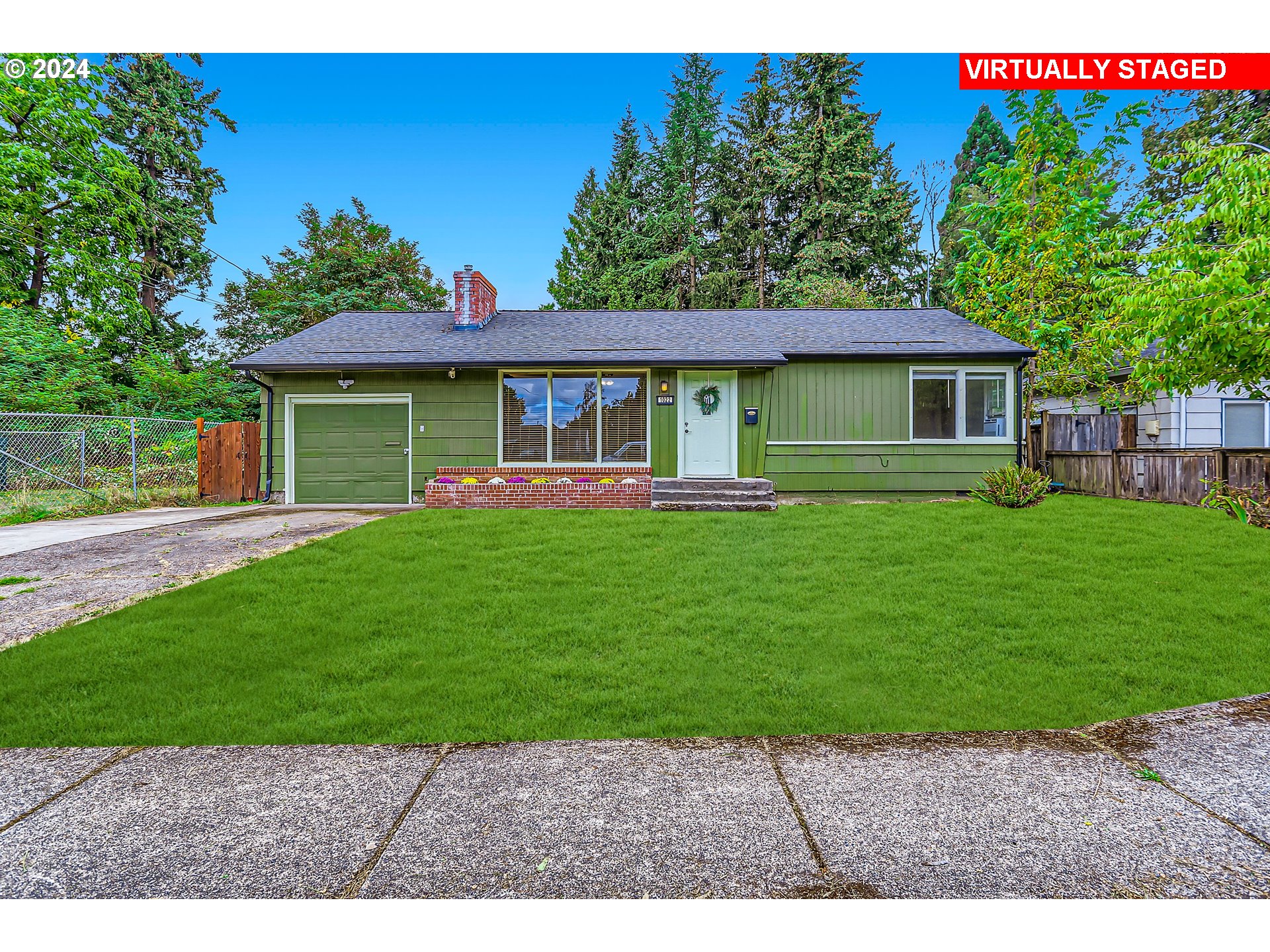 a front view of a house with a yard and potted plants