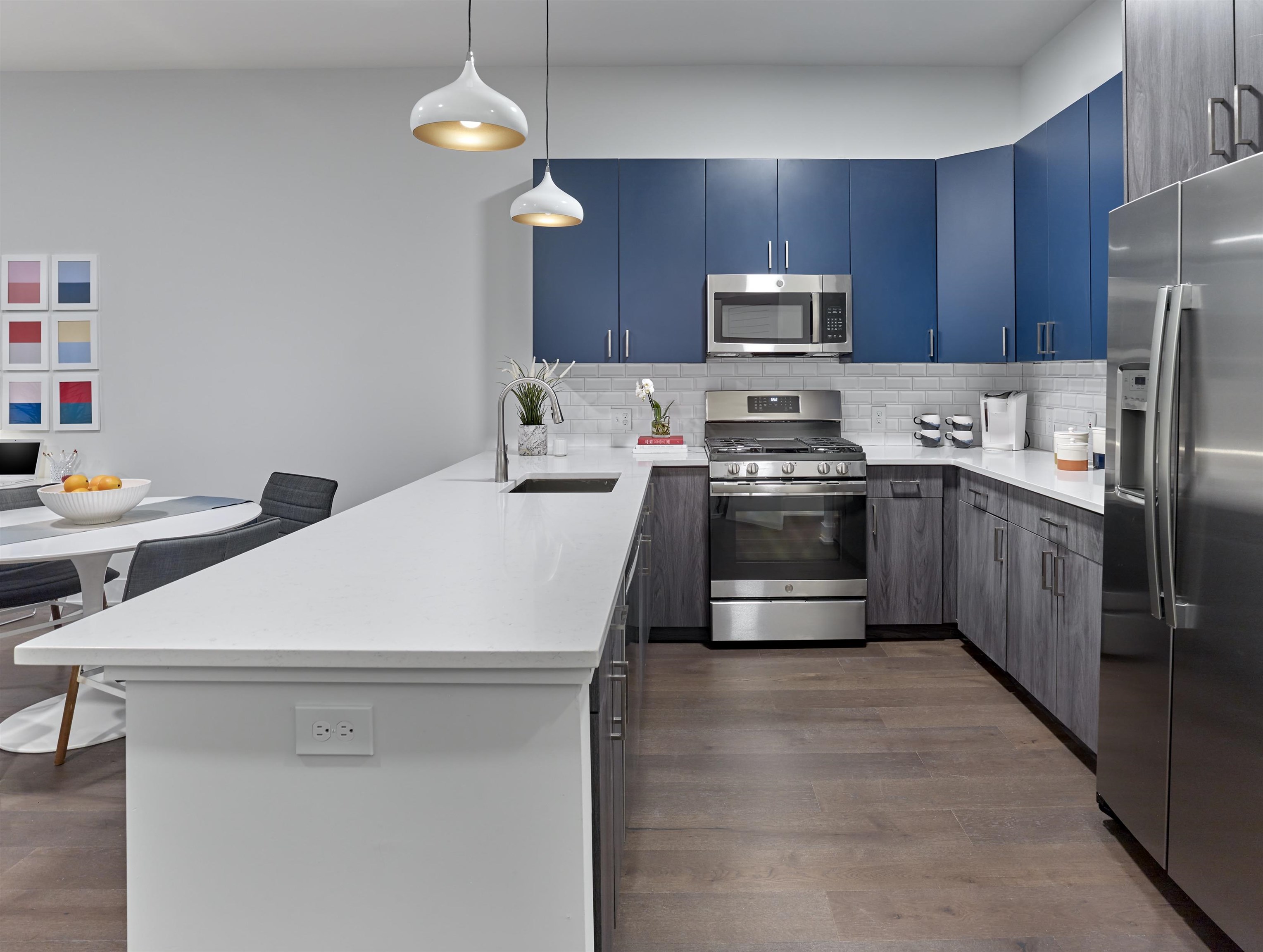 a kitchen with stainless steel appliances a stove a sink and a refrigerator