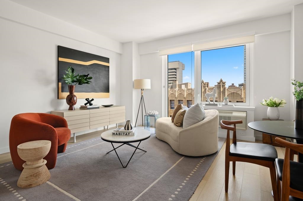 a living room with furniture and a potted plant