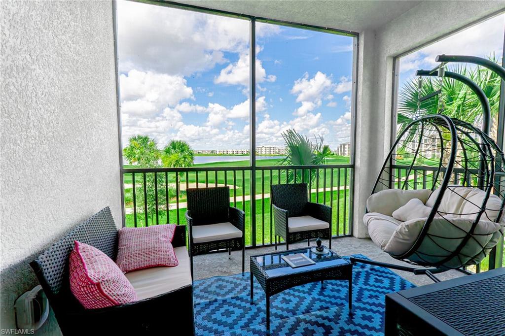 a living room with furniture and a floor to ceiling window