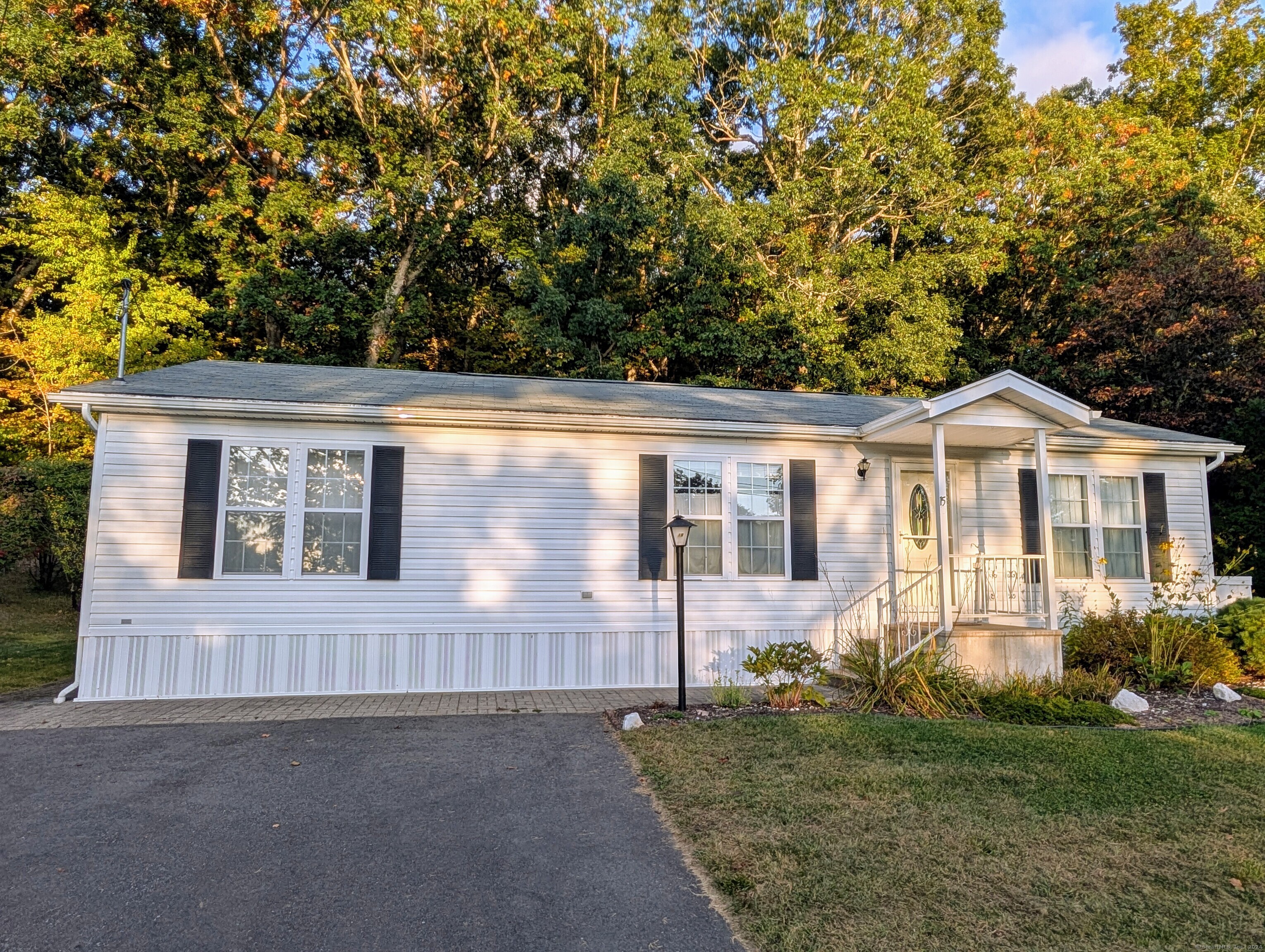 a front view of a house with a yard and porch