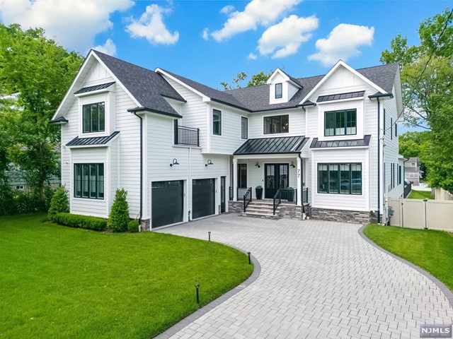 a front view of a house with yard and green space