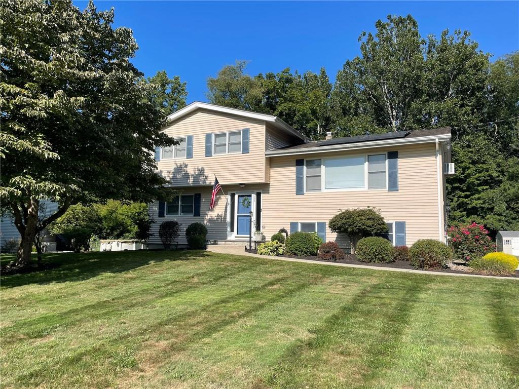 Split level home with a front yard