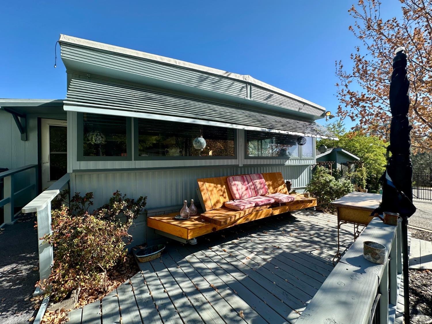 a view of a chairs and tables in the back yard of the house