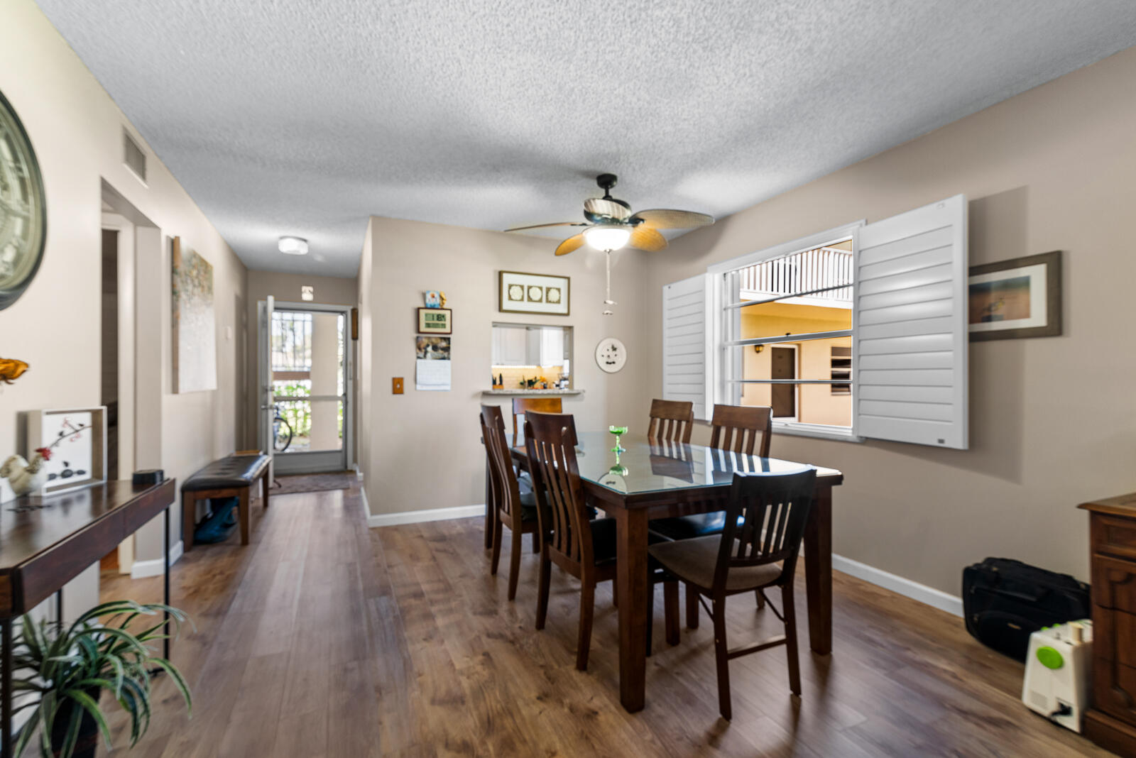 a view of a a dining room with furniture window and wooden floor