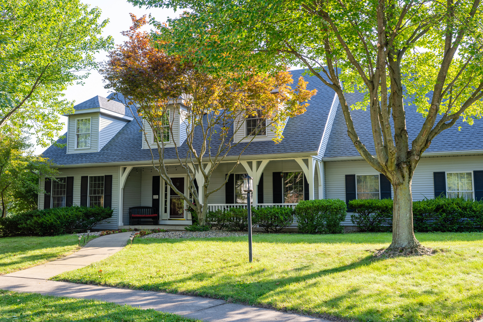 a front view of house with yard and green space