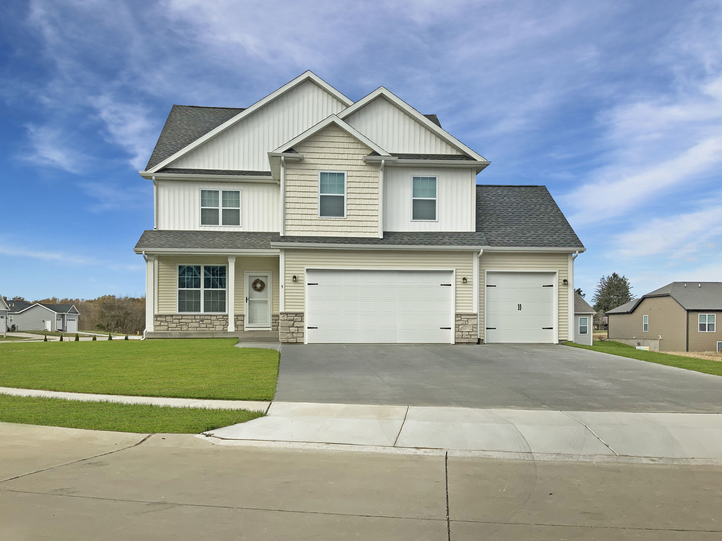 a front view of a house with a garden and yard