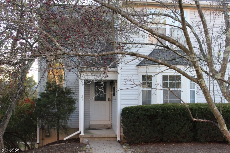 a front view of a house with parking space