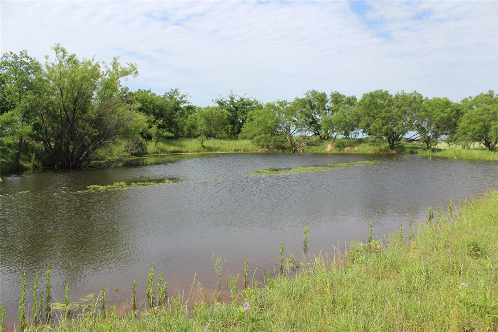 a view of a lake with a house in the background