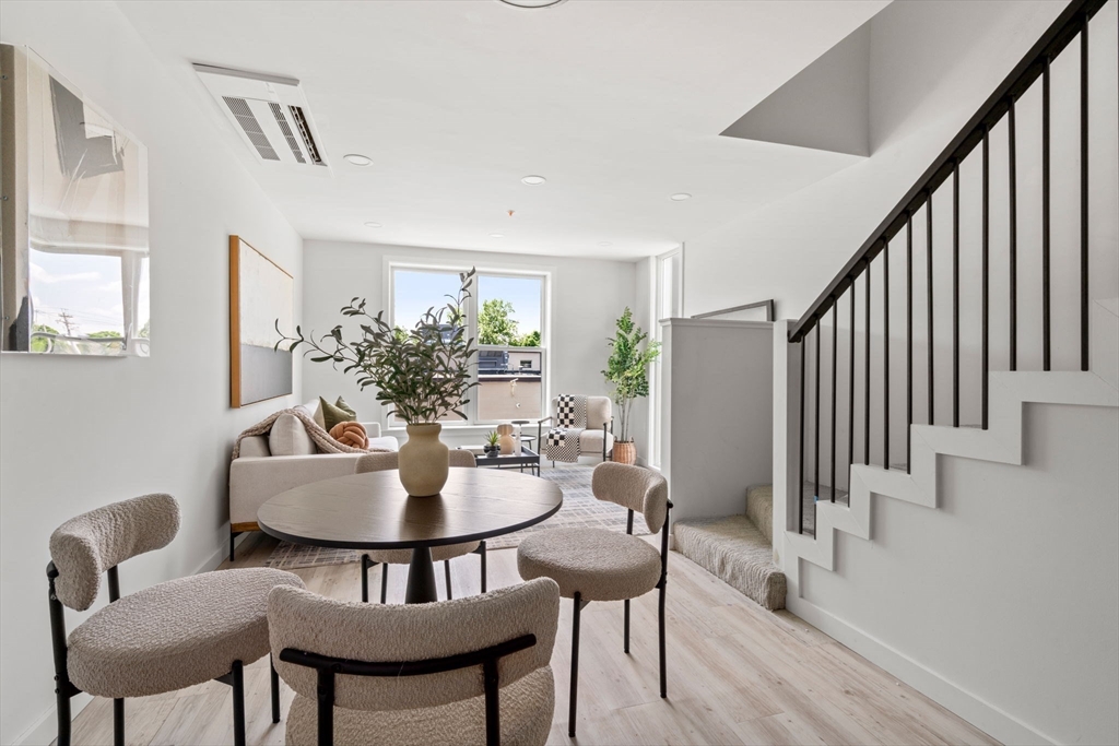 a dining room with furniture and wooden floor