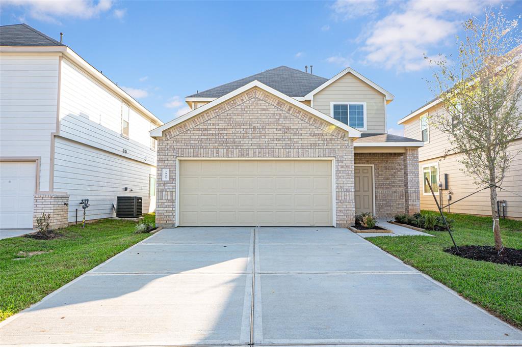 a view of a house with a yard and garage