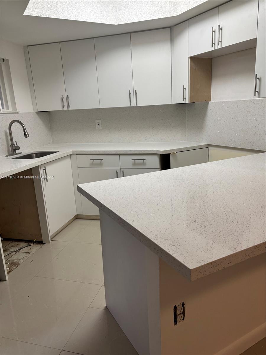 a kitchen with a cabinets and a sink