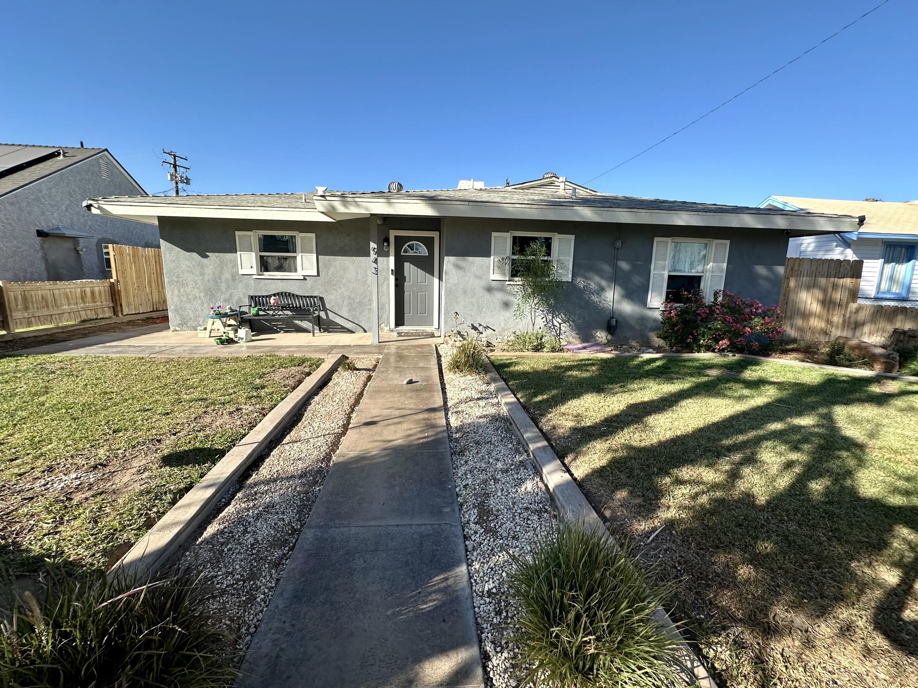 a view of a house with backyard sitting area and garden