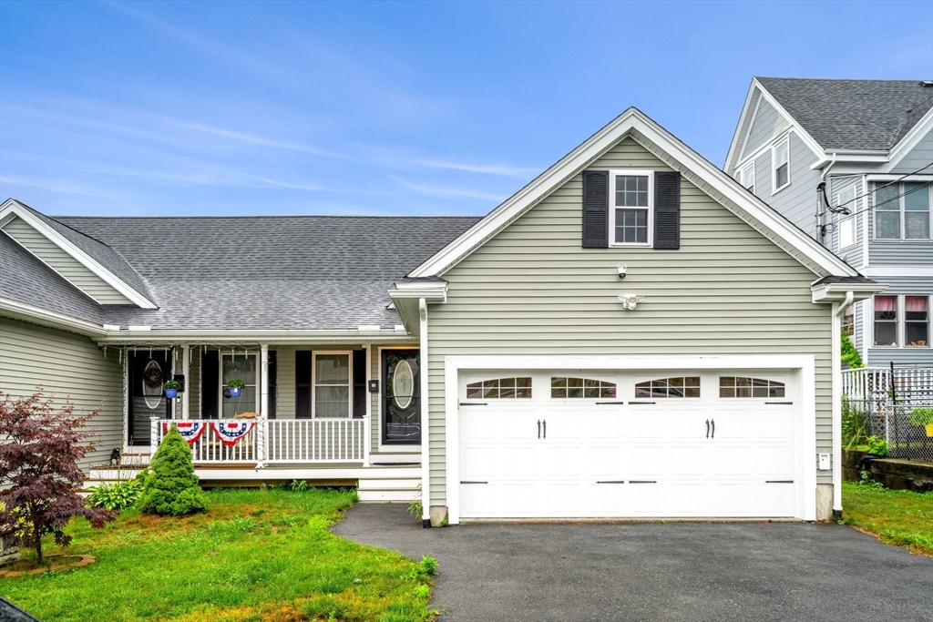 a front view of a house with a yard and porch