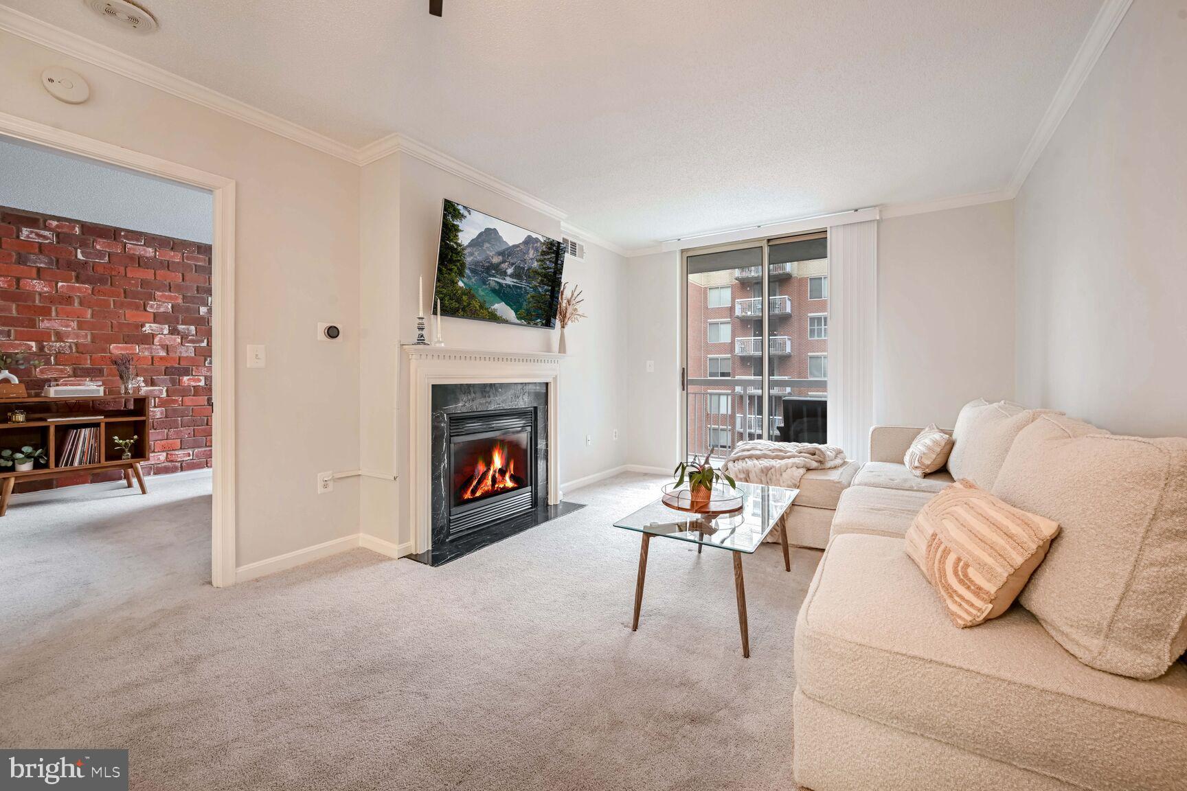 a living room with furniture a fireplace and a flat screen tv