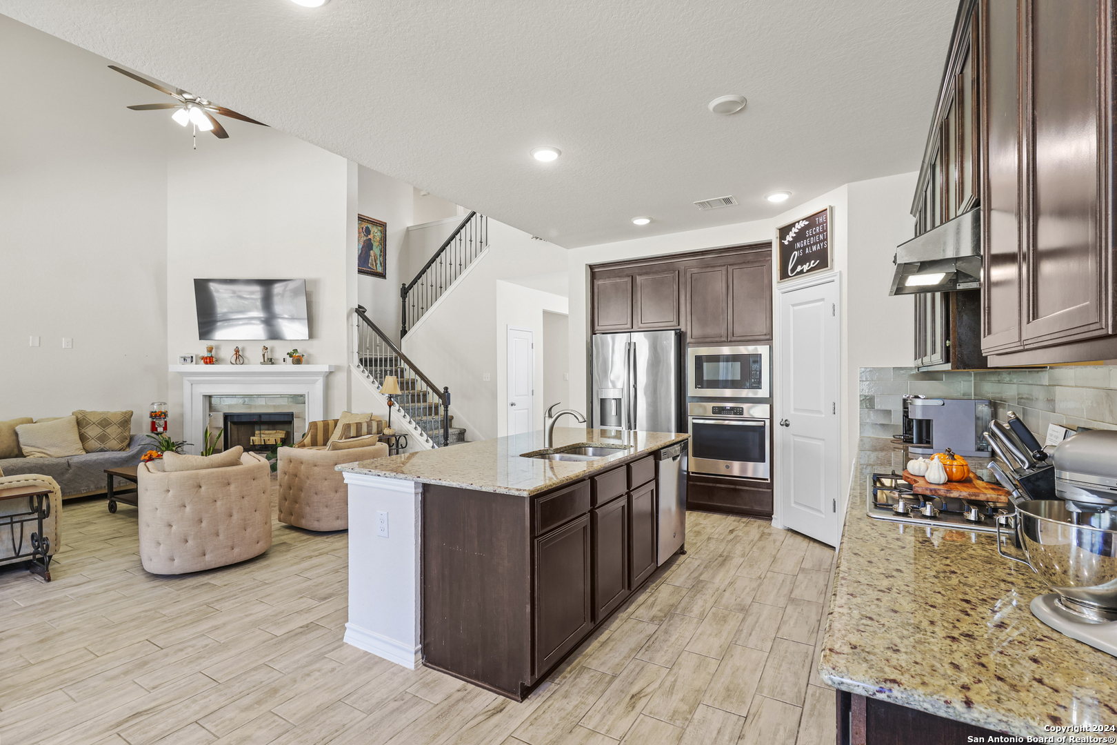 a kitchen with stainless steel appliances granite countertop a stove oven and a refrigerator