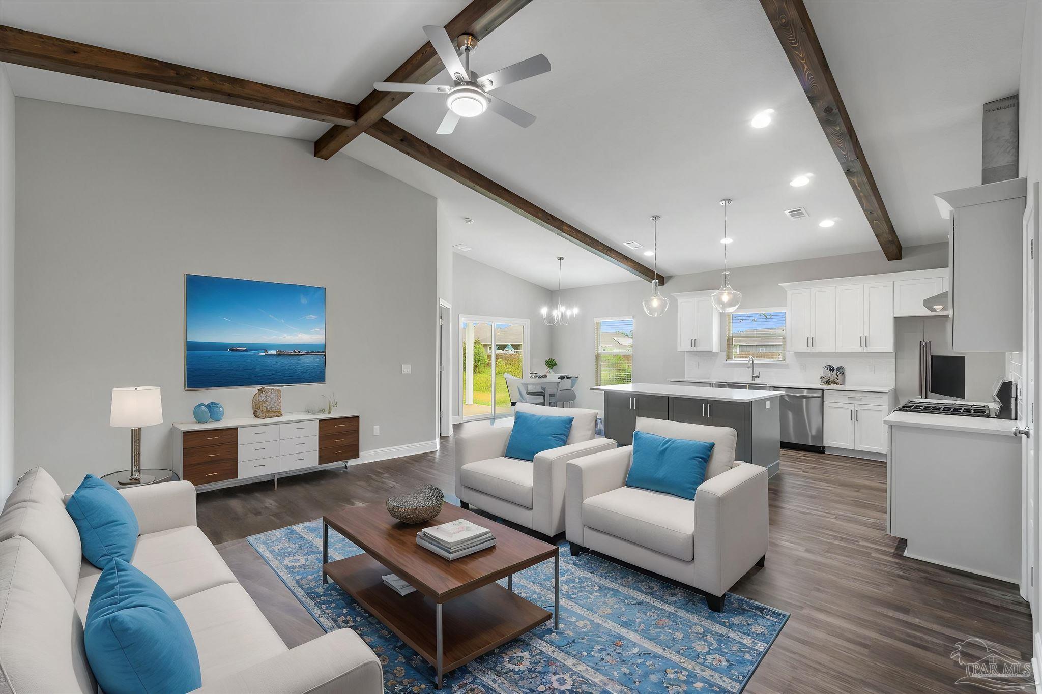 a living room with furniture and a view of kitchen