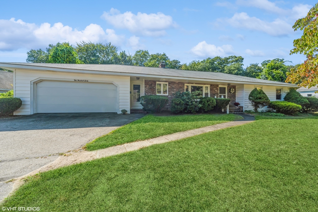 a front view of house with yard and green space