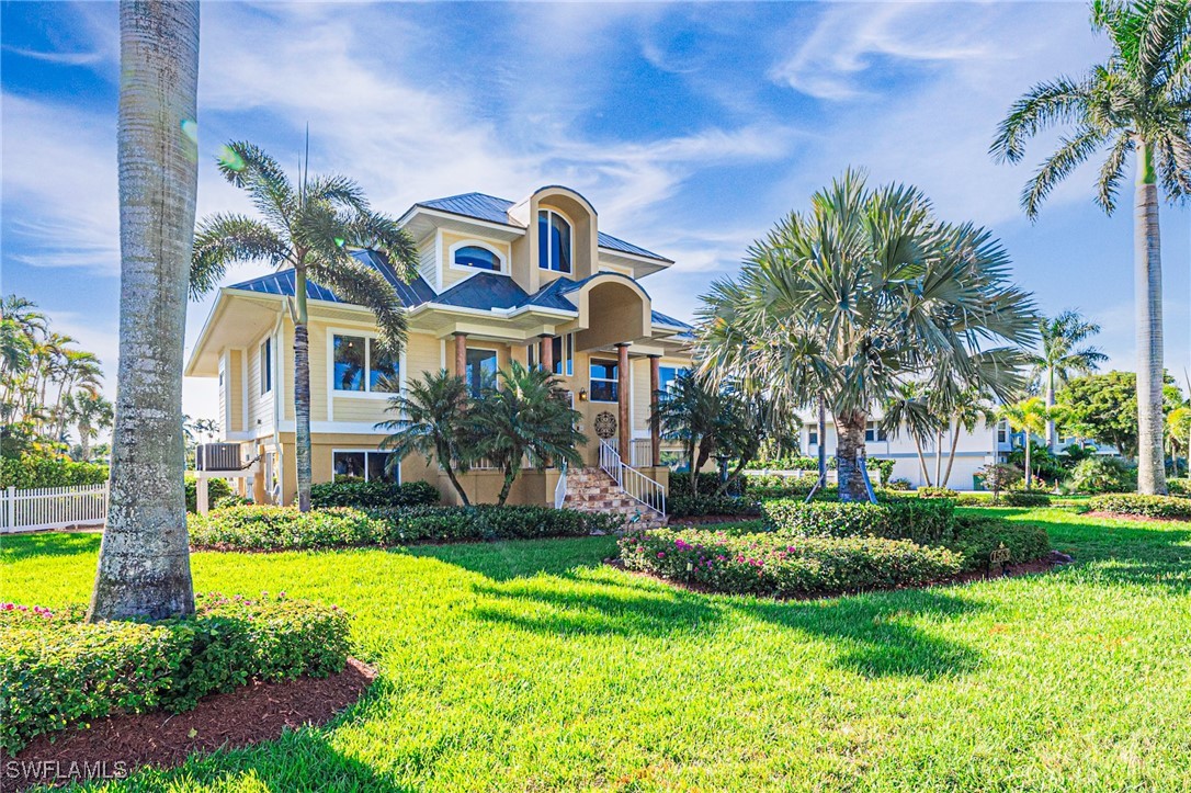 a view of a big building with a big yard and palm trees