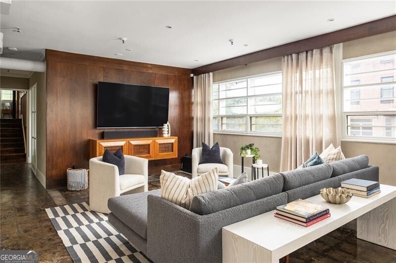 a living room with furniture and a flat screen tv