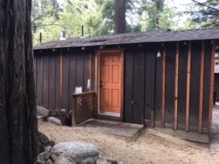 a view of a house with a door and wooden fence