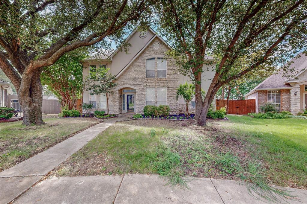 a front view of a house with yard and green space