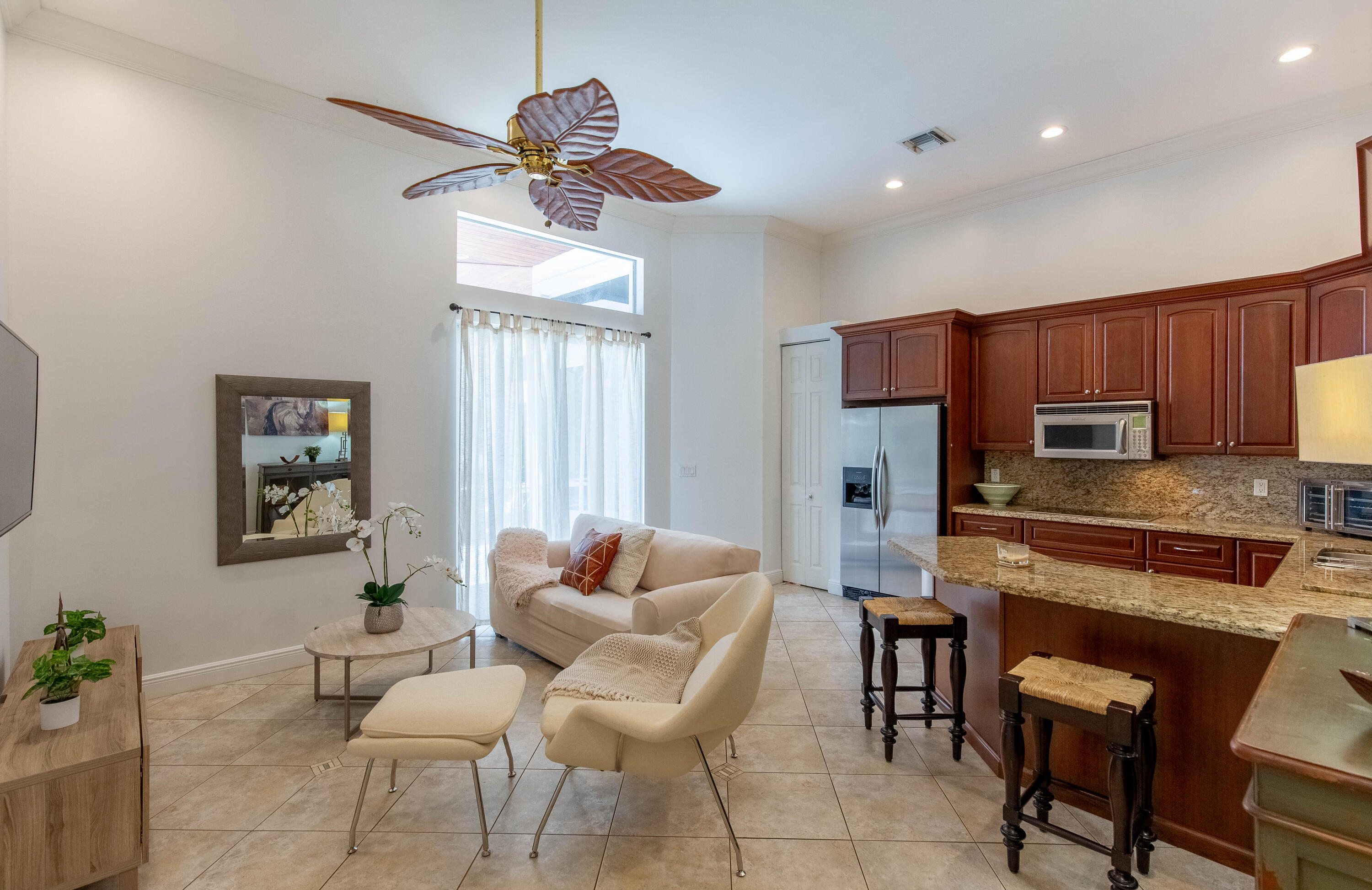 a kitchen with furniture a chandelier and a dining table