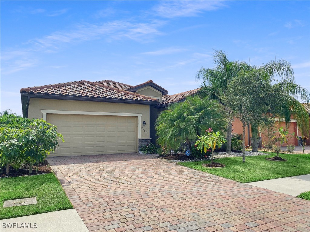 a front view of a house with a garden