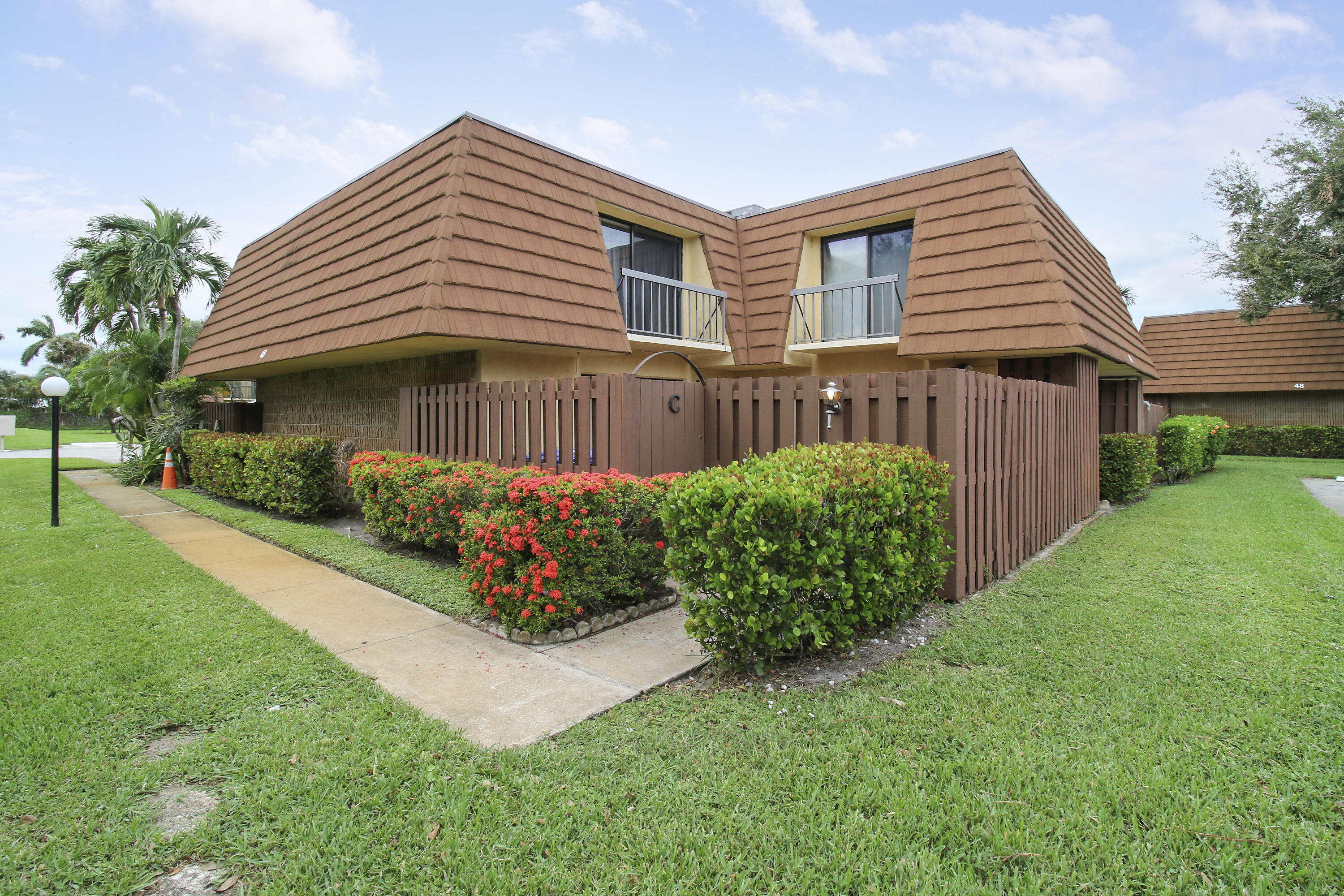 a front view of a house with garden