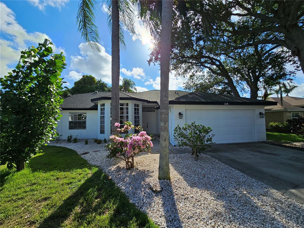 a front view of a house with garden