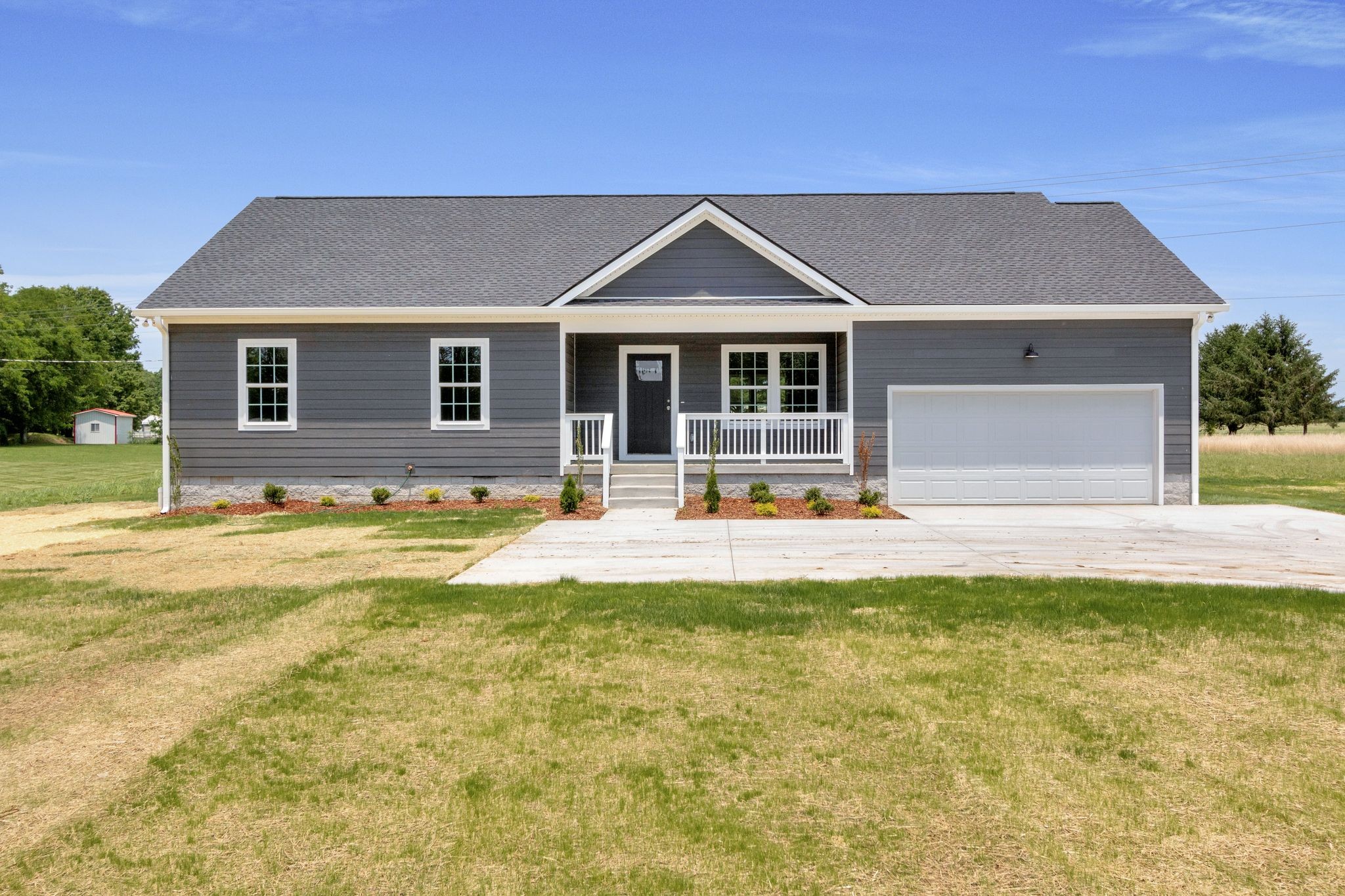 a front view of house with yard and swimming pool