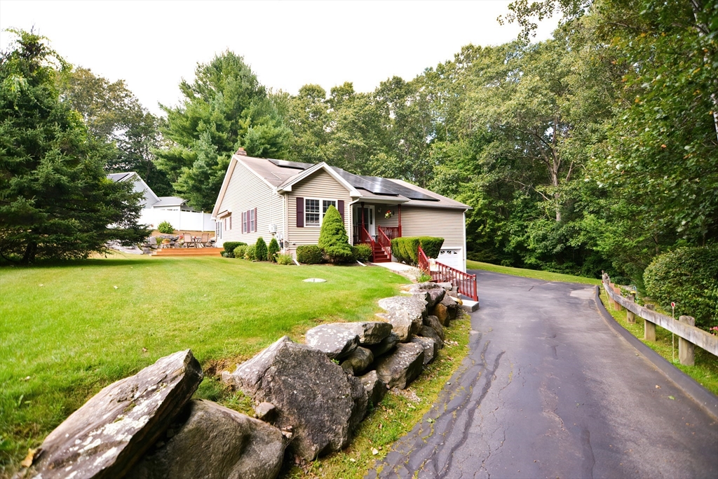 a front view of house with yard and green space