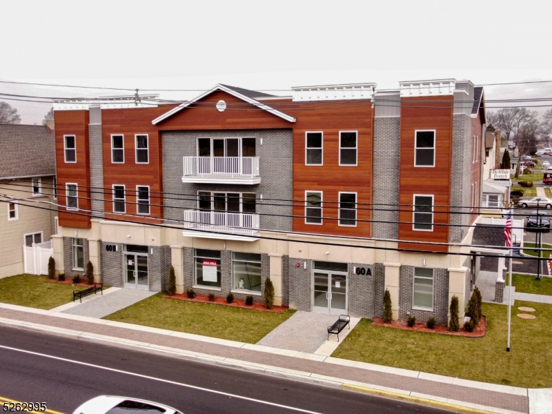 a view of a building with a car parked space