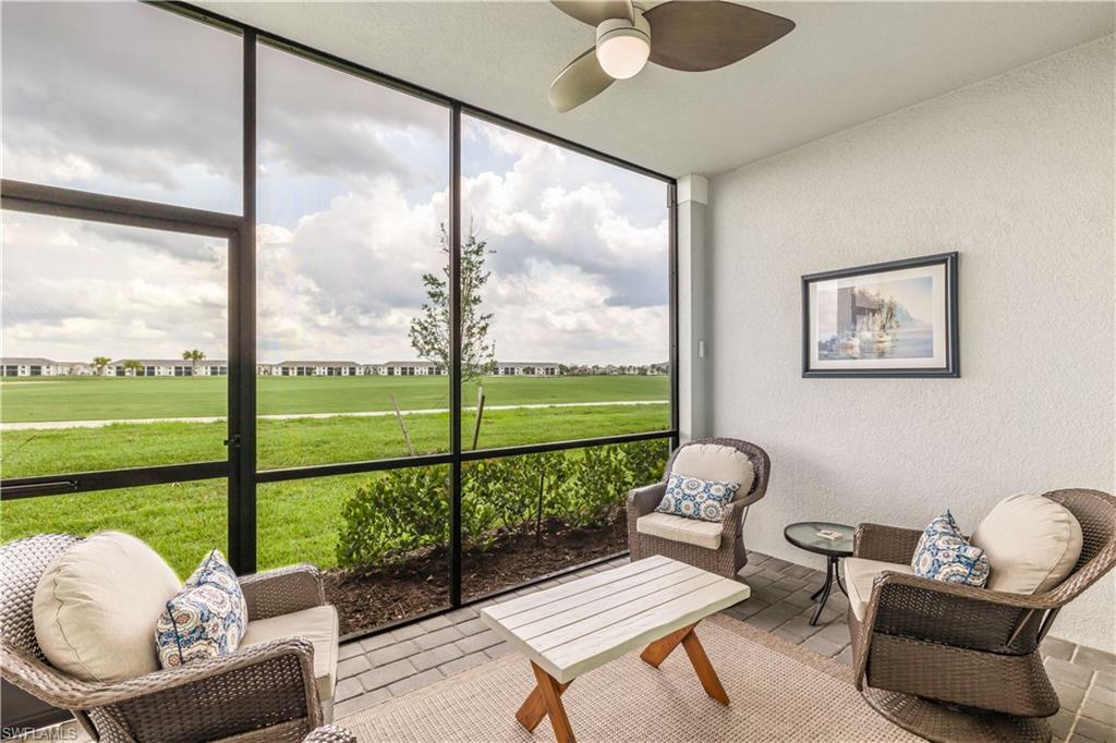 a living room with furniture and a floor to ceiling window