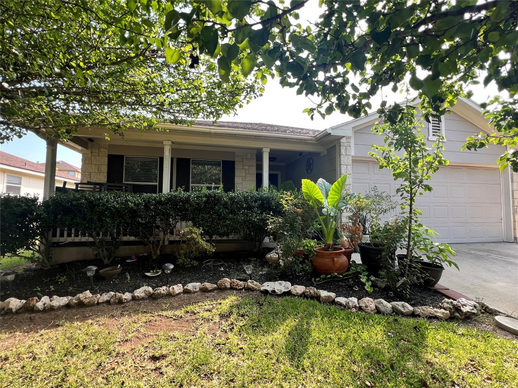 a front view of house with yard and trees around