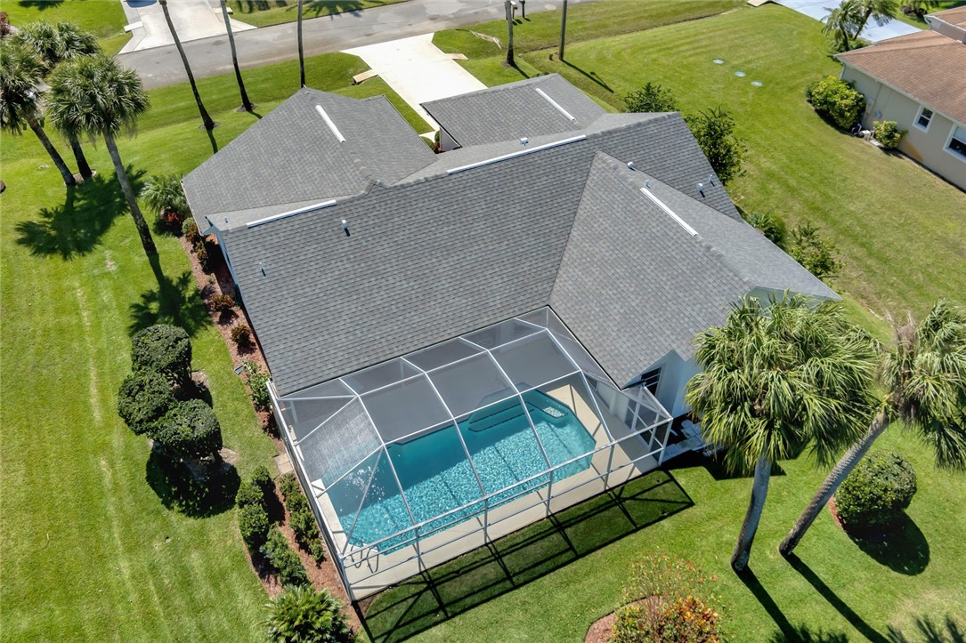 an aerial view of a house with a yard