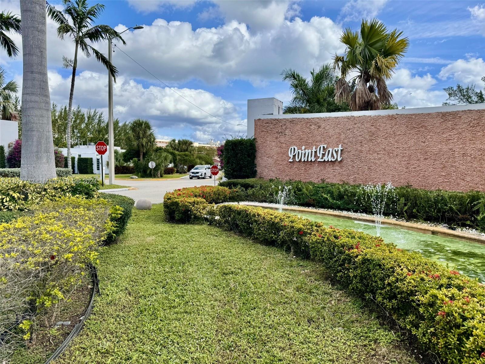 a view of a garden with a building in the background