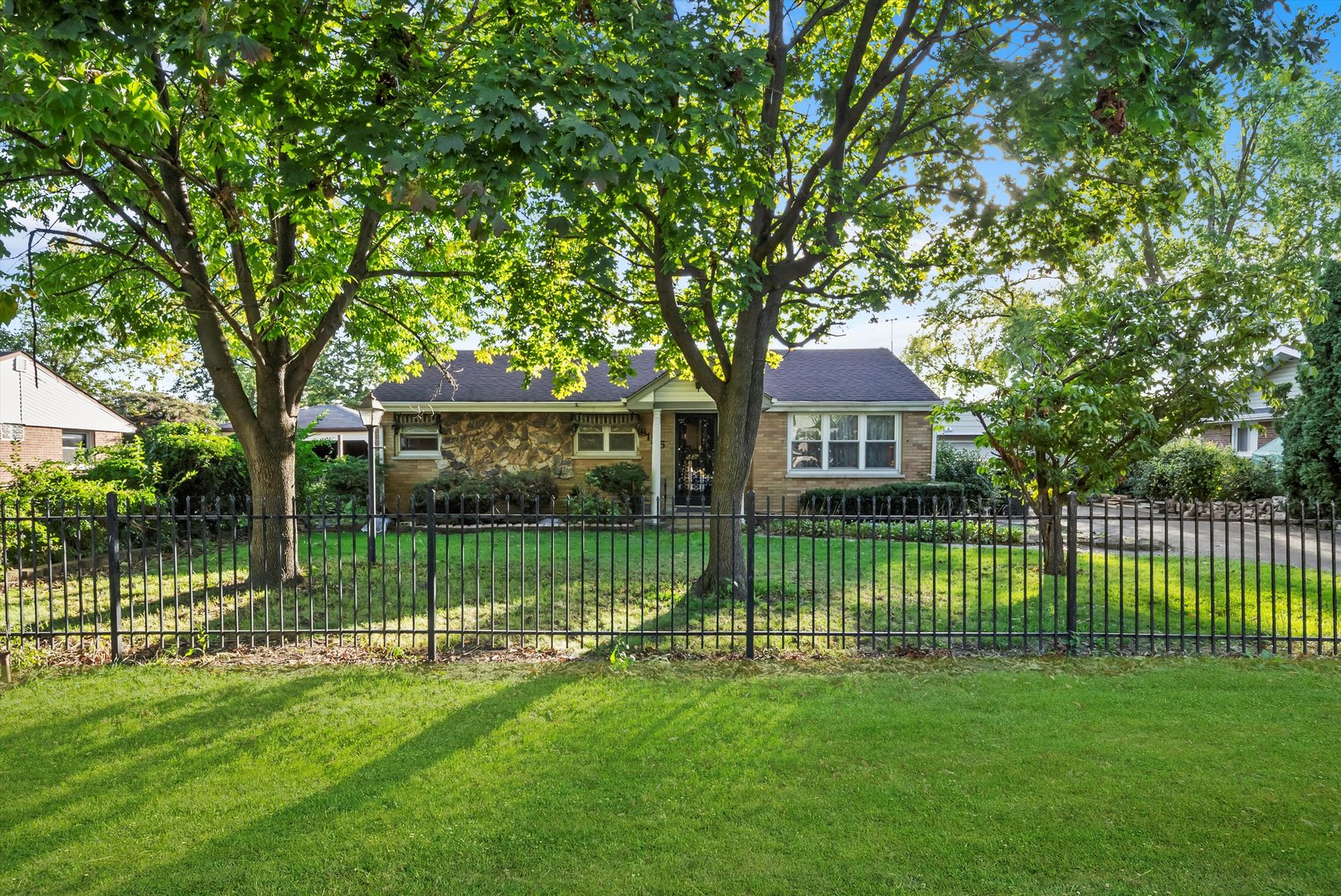 a front view of a house with a garden and yard