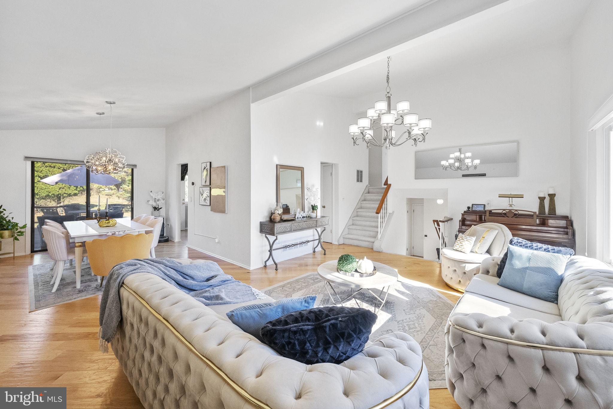 a living room with furniture and a chandelier