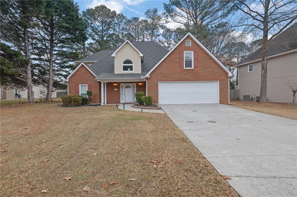 a front view of a house with a yard and garage