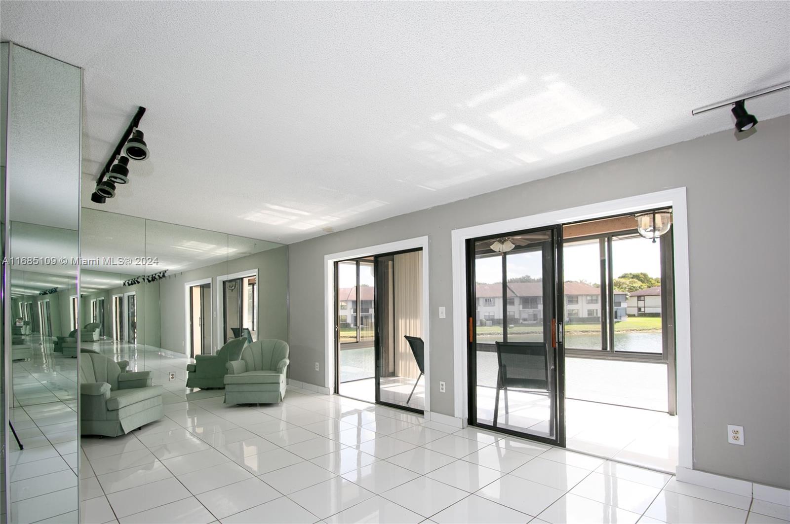 a living room with furniture and large windows