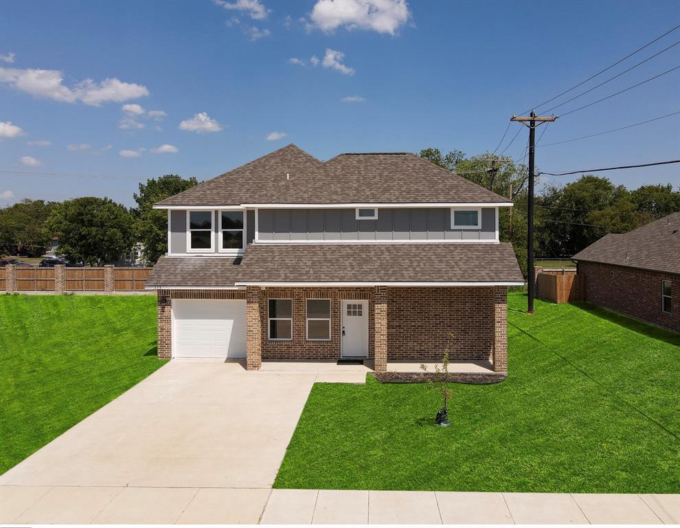 a front view of a house with a yard