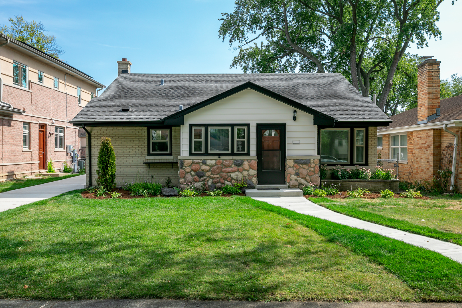 a front view of a house with a yard and porch