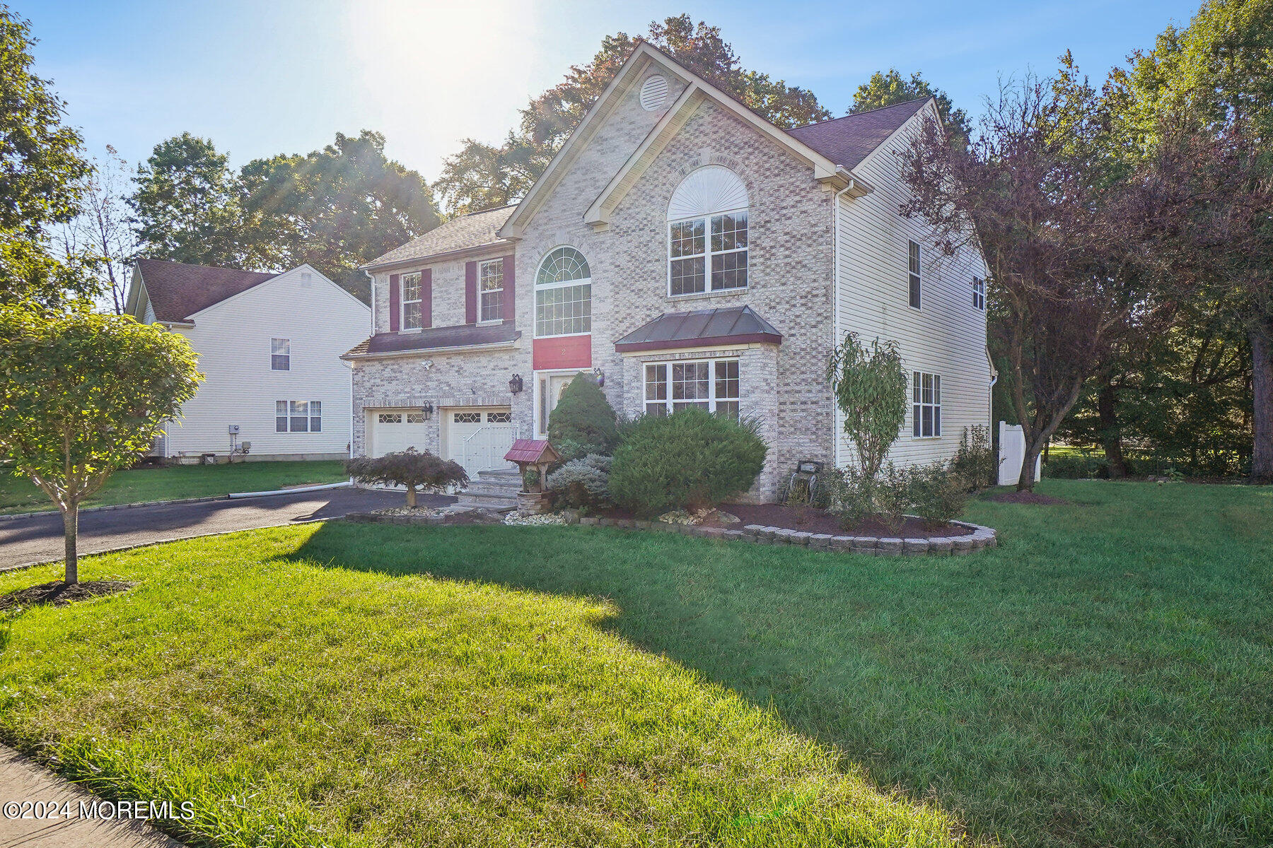 a front view of house with yard and green space