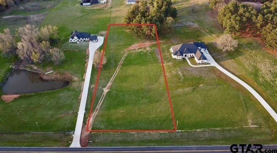 an aerial view of a residential houses with outdoor space