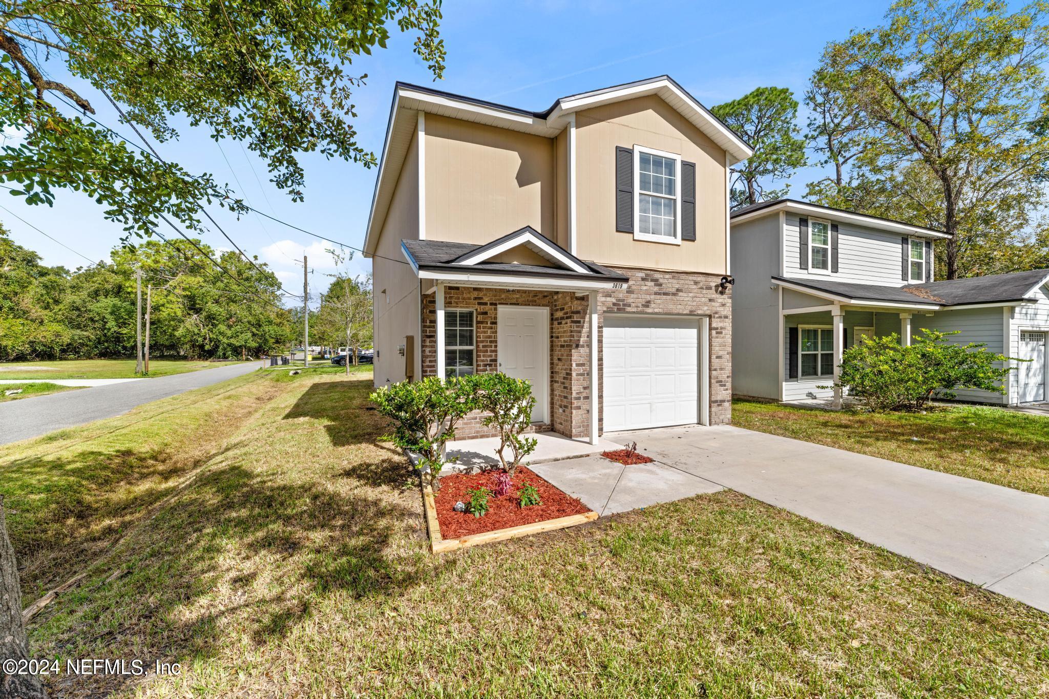 a front view of a house with a yard